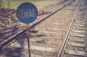 Blue sign by the railroad