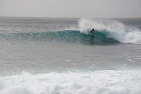 A man surfs the waves in the sea