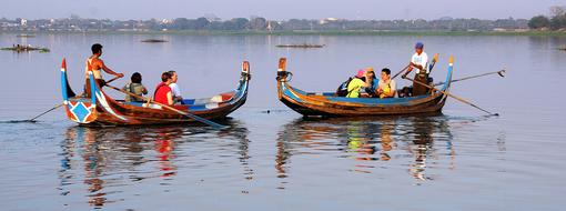 People on boats at sea sport
