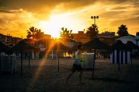 A man runs along the beach