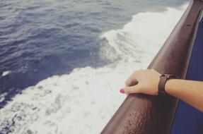 Woman hand against the sea