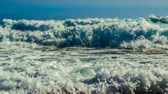 Wave Smashing lush Foam on beach