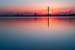 heavy industry, plant on waterside at dusk