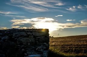 A stone fence wall lit by the sun