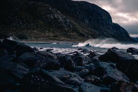 dark rocky coast at cloudy evening