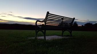 Bench in a green field