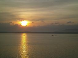 The sun shines on the boat at sea