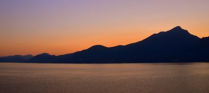 Silhouette of a mountain against the sunset