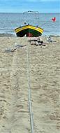 Fishing boat with rope on sand Beach