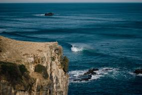 brown cliff near blue sea
