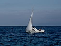 White boat sailing in the blue ocean