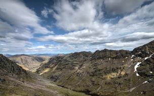 scenic Landscape, mountains, massif beneath fluffy Clouds