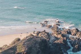 Sandy beach with rocks by the ocean