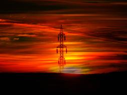 high voltage power Pole at dramatic red sky