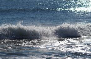 White waves crash against the shore
