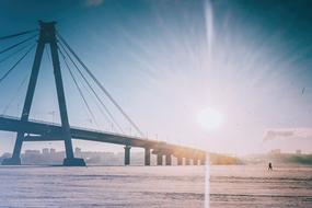 foggy sunrise over bridge at coastal city