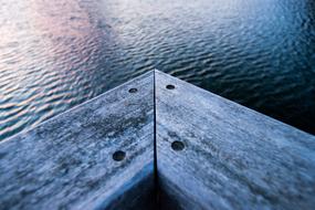 a wooden corner in the lake
