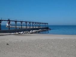 long Pier with Lighthouse on calm sea
