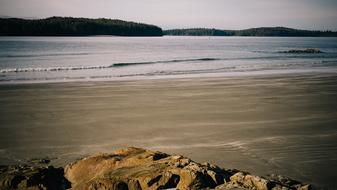 rock at empty gray sand Beach