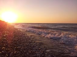 foamy surf on empty beach at Sunset