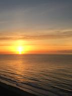 Sunrise, sun at horizon over sea