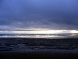 Sand Beach beneath heavy dark clouds