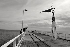 Weather vane on long Pier at sea