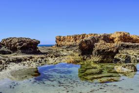 rocky cliffs with moss in the sea