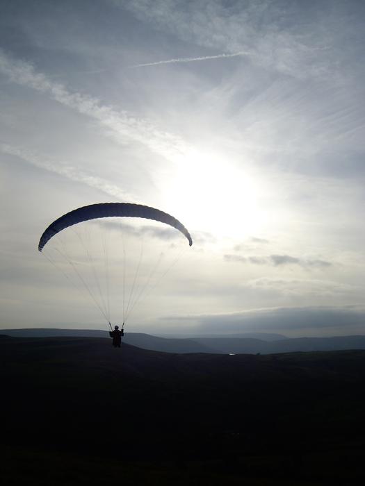 a man on a parachute silhouette
