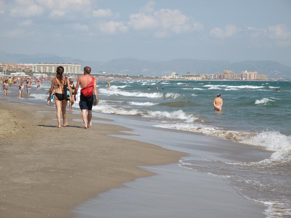 Holidaymakers on the beach by the sea