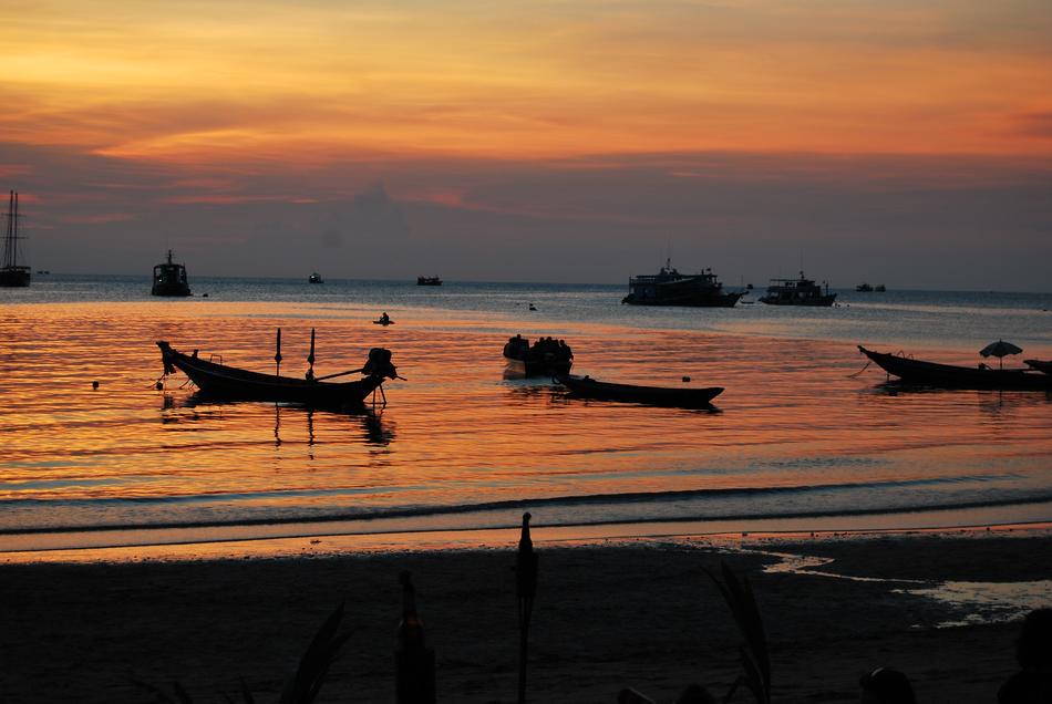 Boat silhouettes at sunset