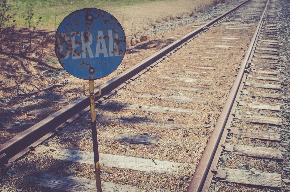 Blue sign by the railroad