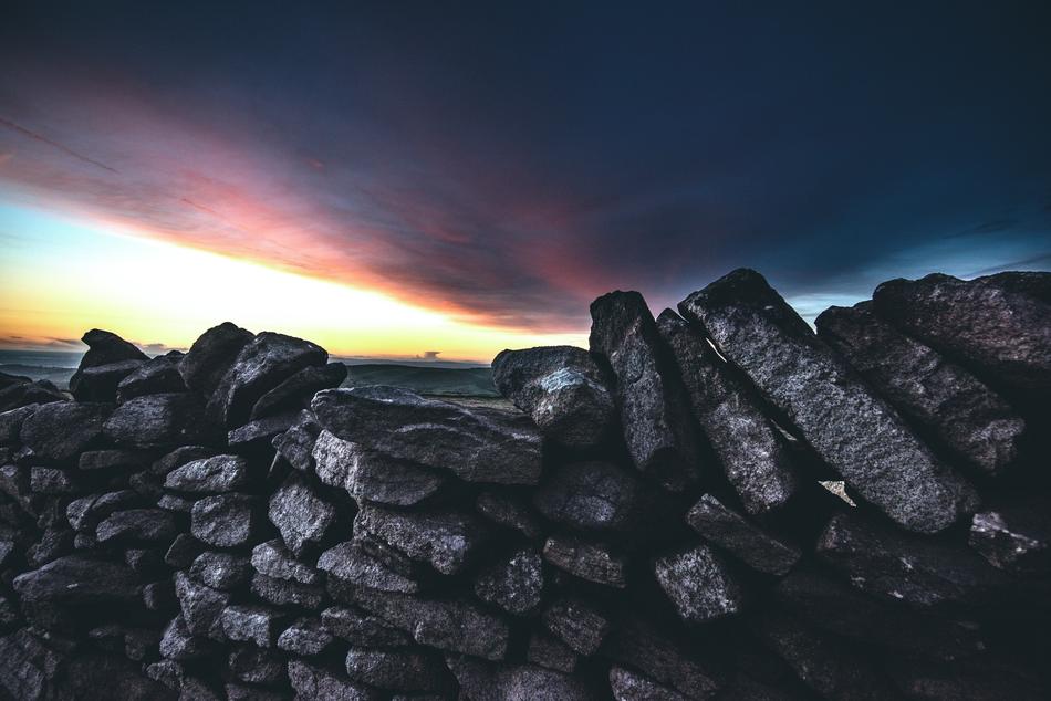 rocks green clouds sunset