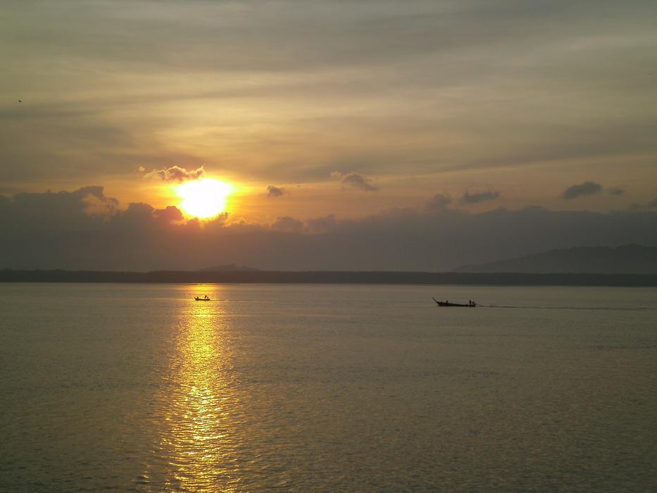 The sun shines on the boat at sea