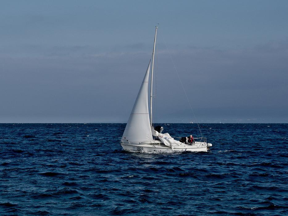 White boat sailing in the blue ocean