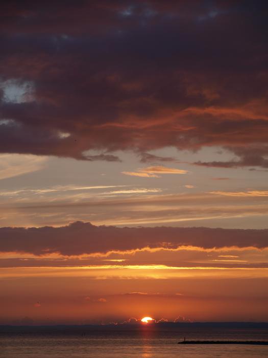 Sunset against the sea with clouds