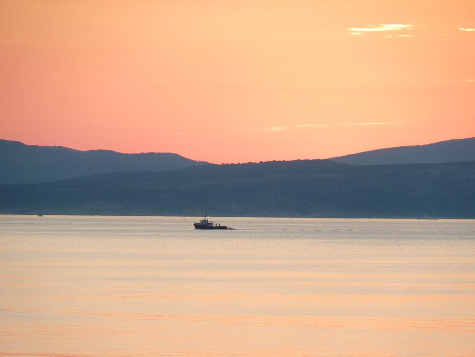 colorful sunset over the sea by the mountains