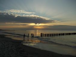 breakwater in Sea beneath dramatic sky