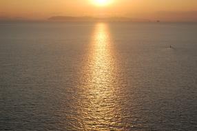 the sea with a sunny road