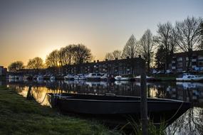 moored Boats near city waterfront at dusk, netherlands