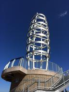 A large radio tower against a blue sky