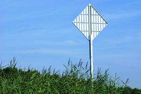 iron road sign on the meadow