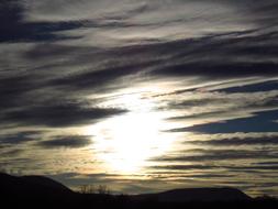the sun illuminates the clouds