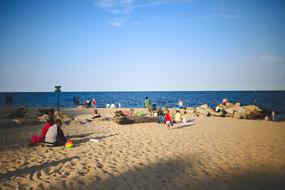 people on the beach by the sea