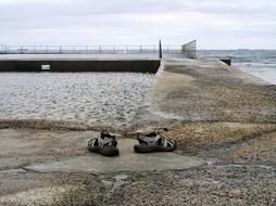 shoes near the stone bridge by the sea