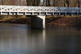 white bridge with a lake