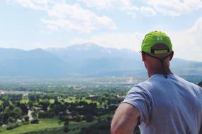 man in green cap