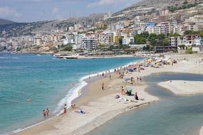 people vacationing by the beach with the sea