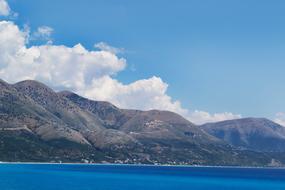 high mountains with clouds by the sea