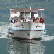 a white yacht with people on the way